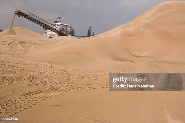 a ship unloading sand at hamilton, ontario - sand pile stock pictures, royalty-free photos & images