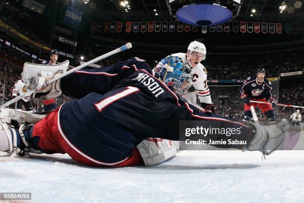 Goaltender Steve Mason of the Columbus Blue Jackets lunges to try and catch a shot by forward Jonathan Toews of the Chicago Blackhawks on April 5,...