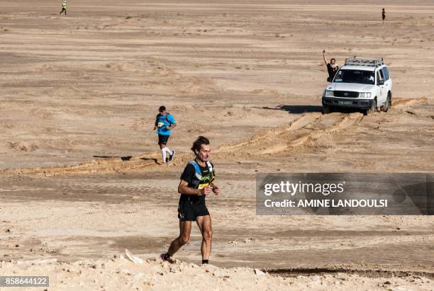 Participants run during the Ultra Mirage El Djerid marathon in the desert near the southwestern Tunisian city of Tozeur on October 7, 2017. - The...