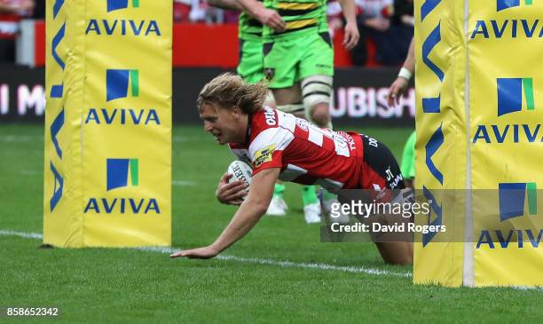 Billy Twelvetrees of Gloucester dives to score their fourth try during the Aviva Premiership match between Gloucester Rugby and Northampton Saints at...