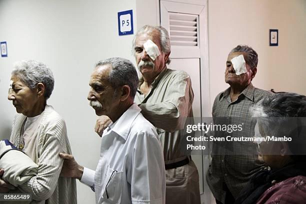 Patients are led out of an operation room after cataract surgery at Cuba's and Venezuela's joint program 'Operacion Milagro,' Operation Miracle, at...