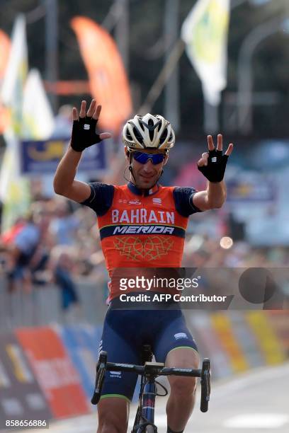 Italy's Vincenzo Nibali from the Bahrain-Merida team gestures as he celebrates victory while crossing the finish line of the 111th edition of The...
