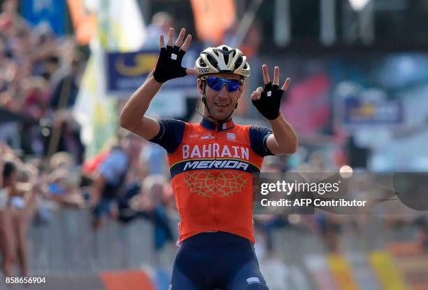 Italy's Vincenzo Nibali from the Bahrain-Merida team gestures as he celebrates victory while crossing the finish line of the 111th edition of The...