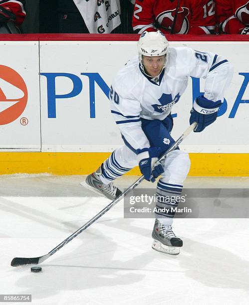 Christian Hanson of the Toronto Maple Leafs plays the puck against the New Jersey Devils at the Prudential Center on April 7, 2009 in Newark, New...