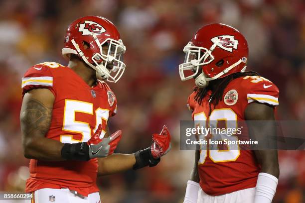 Kansas City Chiefs inside linebacker Derrick Johnson talks with free safety Ron Parker between palys in the second quarter of an NFL game between the...