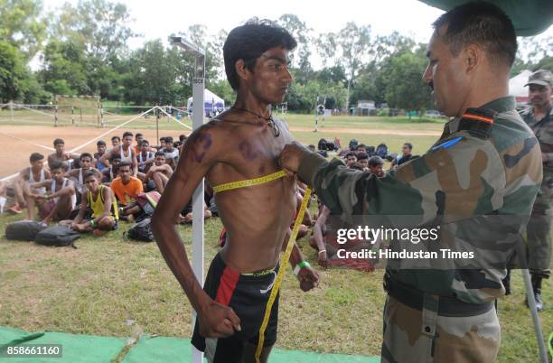 Unemployed youth take part in the physical test during a special recruitment camp of the Indian Army at Morahbadi Ground, on October 7, 2017 in...