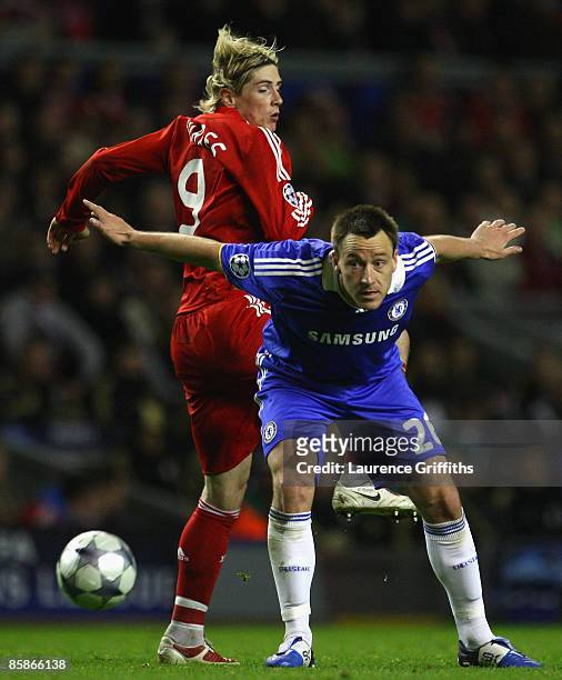 John Terry of Chelsea competes for the ball with Fernando Torres of Liverpool during the UEFA Champions League Quarter Final First Leg match between...