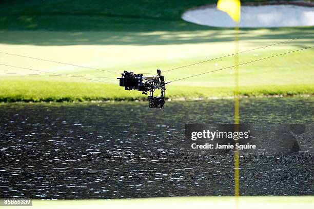 Television camera hangs over the pond off the nineth hole during the Par 3 Contest prior to the 2009 Masters Tournament at Augusta National Golf Club...