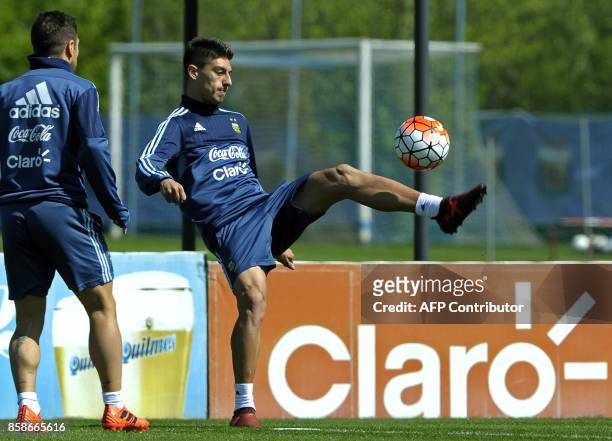 Argentina's midfielder Emiliano Rigoni controls the ball next to forward Lautaro Acosta during a training session in Ezeiza, Buenos Aires on October...