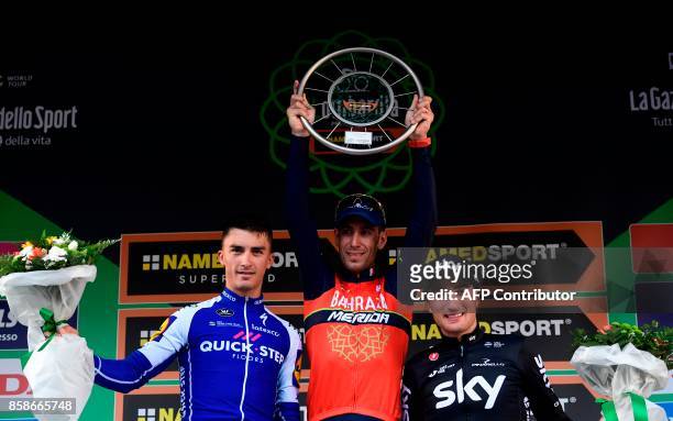 Second-placed French Julien Alaphilippe from Quick-Step floor team, first-placed Italian Vincenzo Nibali from Bahrein-Merida team and thrid-placed...
