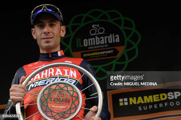 Italian cyclist Vincenzo Nibali from Bahrein-Merida team celebrates with the trophy on the podium during the price ceremony after winning the 111th...