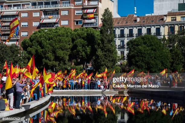 People waiving Spanish flags during a demonstration demanding the unity of Spain and against the independence of Catalonia.
