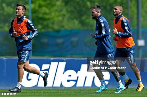 Argentina's farwards Lionel Messi , Paulo Dybala and Mauro Icardi run during a training session in Ezeiza, Buenos Aires on October 7, 2017 ahead of a...