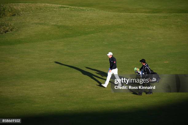 Paul Dunne of Ireland walks down the 9th fairway with his caddie during day three of the 2017 Alfred Dunhill Championship at Kingsbarns on October 7,...