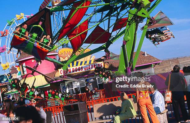 people on ride at santa cruz beach boardwalk. - santa cruz california beach stock pictures, royalty-free photos & images