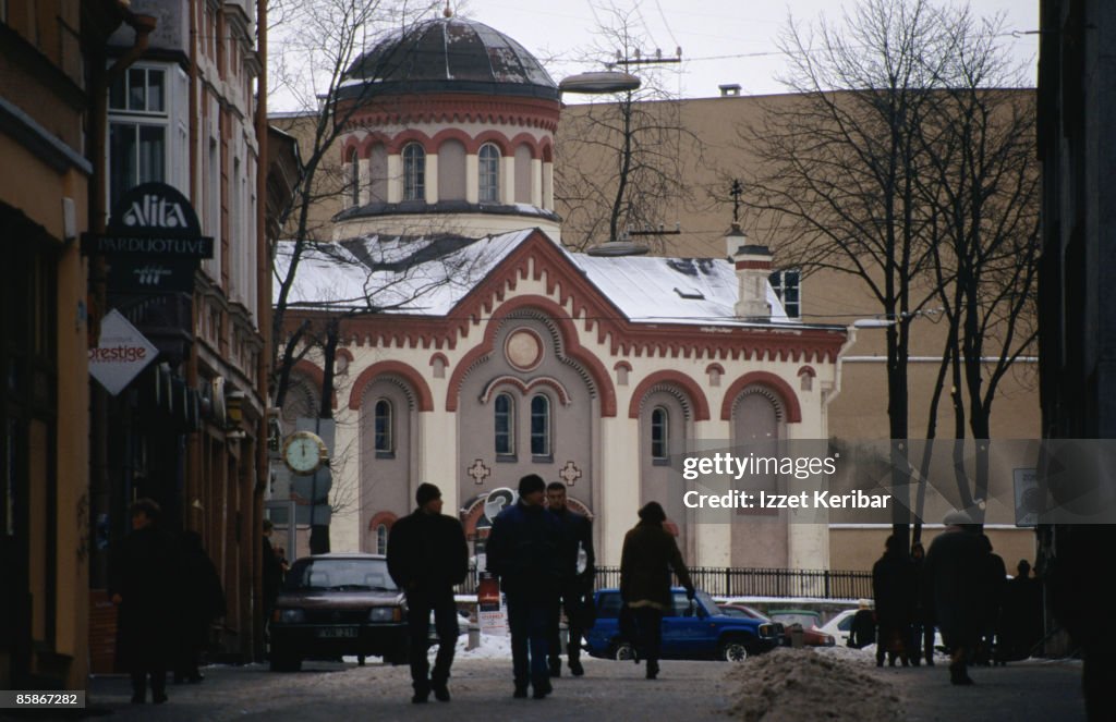 People walking toward a church.