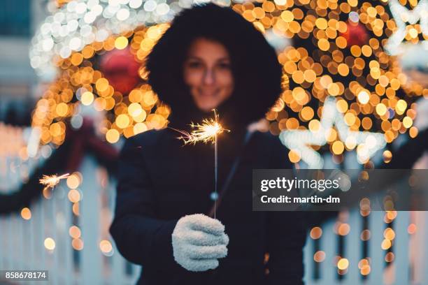 young woman with burning sparkler for christmas - krakow stock pictures, royalty-free photos & images