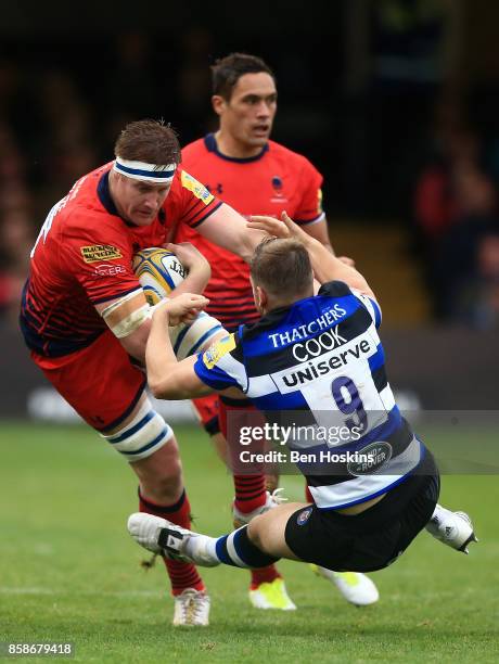 Van Velze of Worcester hands off the tackle of Chris Cook of Bath during the Aviva Premiership match between Bath Rugby and Worcester Warriors at...