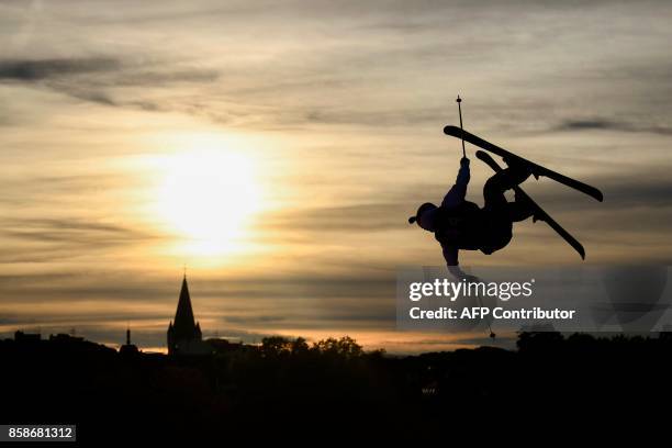 Freestyle skier performs at sunset during the Sosh Big Air, a competition of freestyle skiers and snowboarders, in Annecy on October 7, 2017 as part...