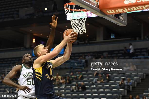 Domantas Sabonis of the Indiana Pacers is defended by Joel Anthony of the Milwaukee Bucks during the second half of a preseason game at the BMO...