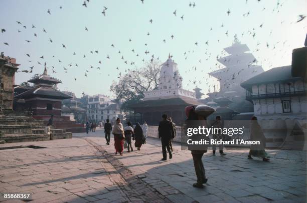 people walking in durbar square. - durbar square stock pictures, royalty-free photos & images