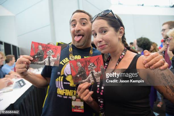 Fan pose with autographed postcards during the Robot Chicken signing during New York Comic Con 2017 - JK at Jacob K. Javits Convention Center on...