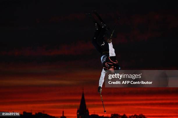 Freestyle skier performs at sunset during the Sosh Big Air, a competition of freestyle skiers and snowboarders, in Annecy on October 7, 2017 as part...