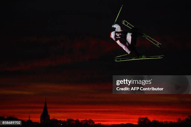 Freestyle skier performs at sunset during the Sosh Big Air, a competition of freestyle skiers and snowboarders, in Annecy on October 7, 2017 as part...