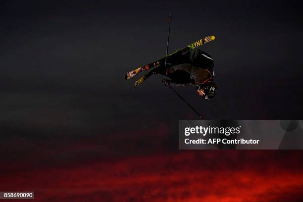 Freestyle skier performs at sunset during the Sosh Big Air, a competition of freestyle skiers and snowboarders, in Annecy on October 7, 2017 as part...