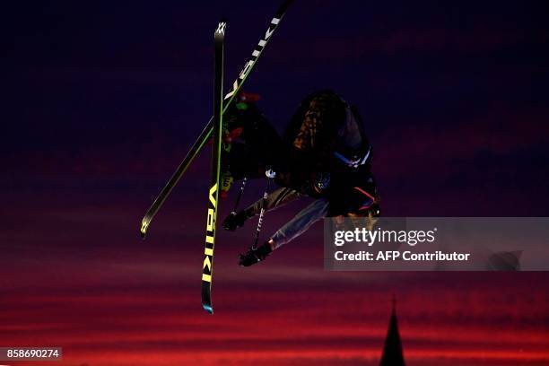 Freestyle skier performs at sunset during the Sosh Big Air, a competition of freestyle skiers and snowboarders, in Annecy on October 7, 2017 as part...