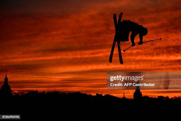 Freestyle skier performs at sunset during the Sosh Big Air, a competition of freestyle skiers and snowboarders, in Annecy on October 7, 2017 as part...