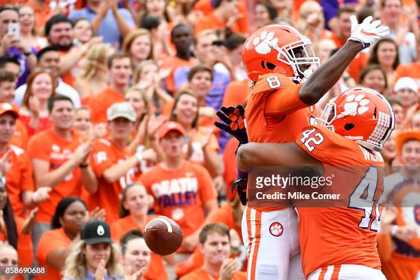 Wide receiver Deon Cain of the Clemson Tigers celebrates with Christian Wilkins of the Clemson Tigers after making a touchdown reception during the...