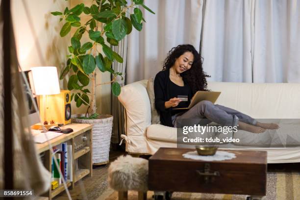 a woman using a laptop - tdub_video stock pictures, royalty-free photos & images