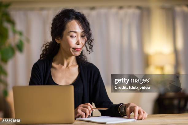 a woman working - tdub_video stock pictures, royalty-free photos & images