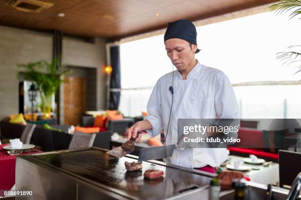 a man cooking at a restaurant - tdub_video stock pictures, royalty-free photos & images