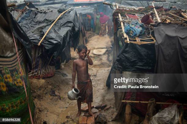 Rohingya boy cries as monsoon rains continue to batter the area causing more difficulties October 7, Thainkhali camp, Cox's Bazar, Bangladesh. Well...