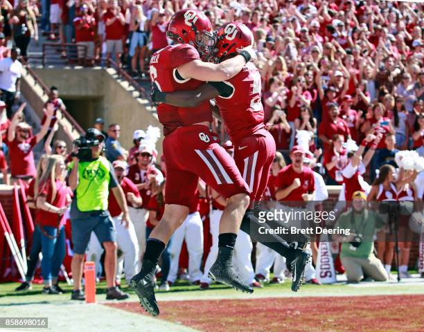 Quarterback Baker Mayfield and wide receiver Marquise Brown of the Oklahoma Sooners celebrate Mayfield's touchdown against the Iowa State Cyclones at...