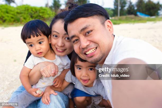 family at the beach - tdub_video stock pictures, royalty-free photos & images