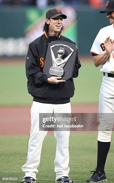 Pitcher Tim Lincecum of the San Francisco Giants celebrates after receiving his 2008 Cy Young award before his game against the Milwaukee Brewers at...