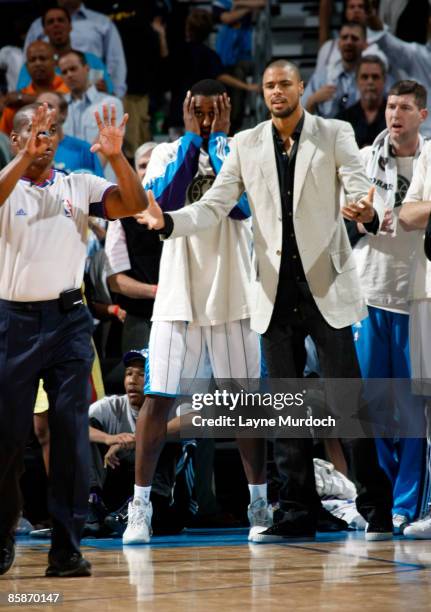 Hilton Armstrong, Tyson Chandler and Ryan Bowen of the New Orleans Hornets react to a call made by referee Derrick Collins during the Hornets' game...