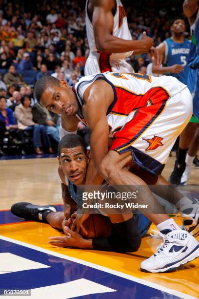 Kevin Ollie of the Minnesota Timberwolves and C.J. Watson of the Golden State Warrior go for the ball during the game on April 8, 2009 at Oracle...