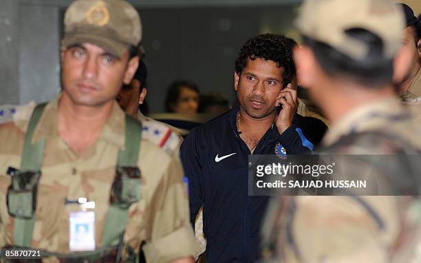 Indian cricketer Sachin Tendulkar walks out of the city airport after arriving from New Zealand in Mumbai late April 8, 2009. The Indian cricket team...