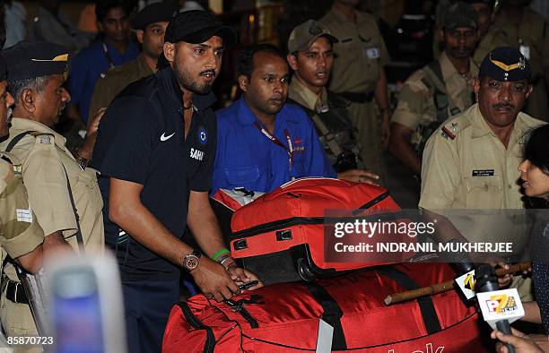 Indian cricketer Harbhajan Singh walks out of the city airport after arriving from New Zealand in Mumbai late April 8, 2009. The Indian cricket team...