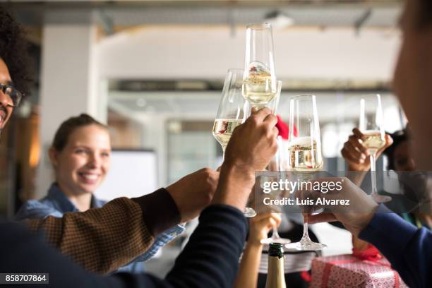 business people toasting champagne flutes while celebrating christmas - christmas party stock pictures, royalty-free photos & images