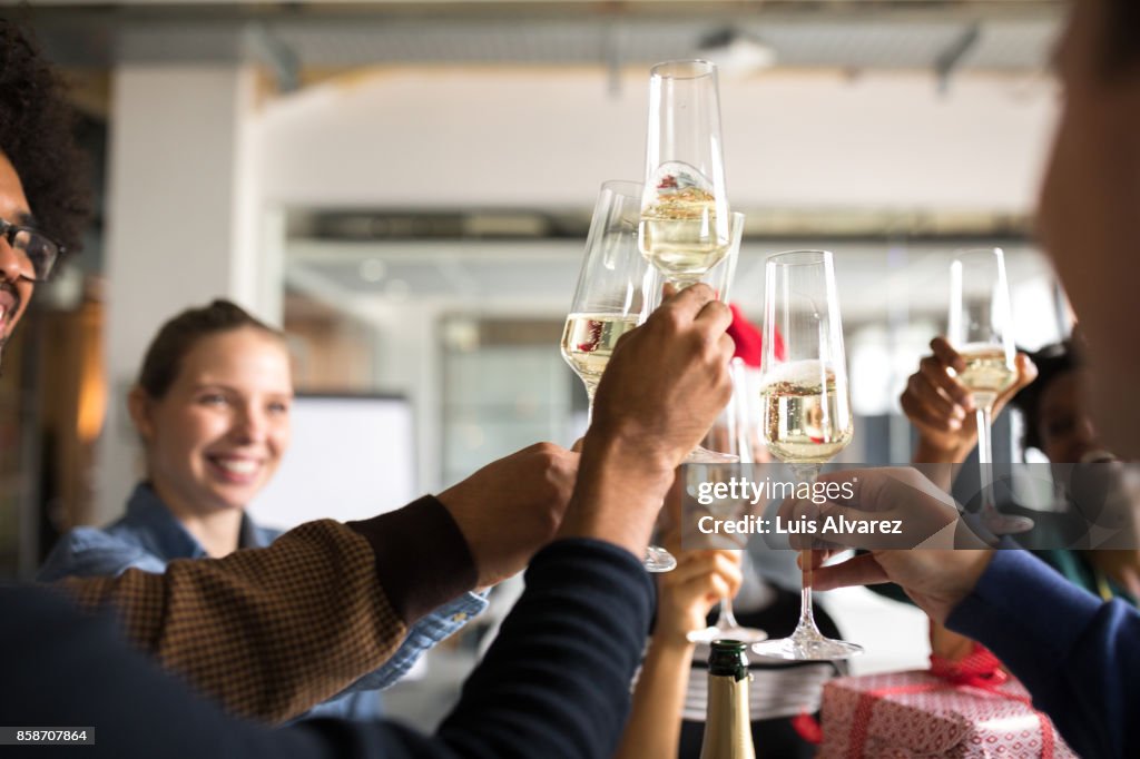 Business people toasting champagne flutes while celebrating Christmas