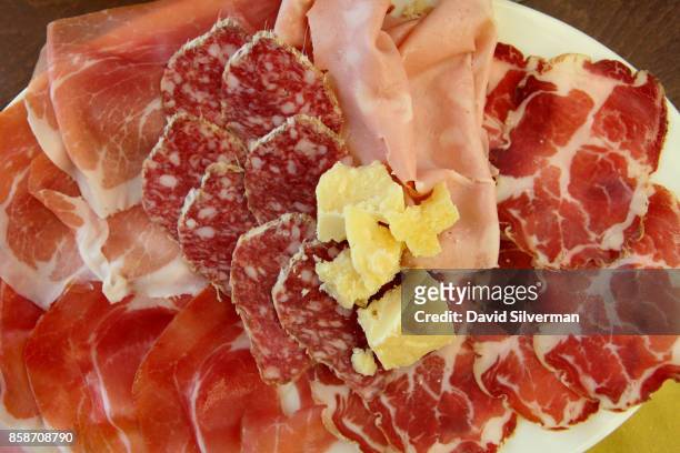 Platter of regional specialties of Prosciutto di Parma, salami, Culatello and Parmesan cheese is served at Antica Salumeria Giorgio Pancaldi, a...