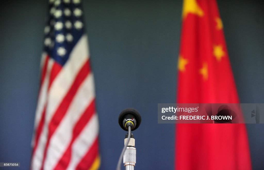 The US and China flags stand behind a mi