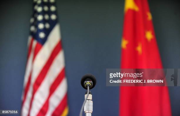 The US and China flags stand behind a microphone awaiting the arrival of US Senator John McCain, who was joined by Senators Lindsey Graham Amy...