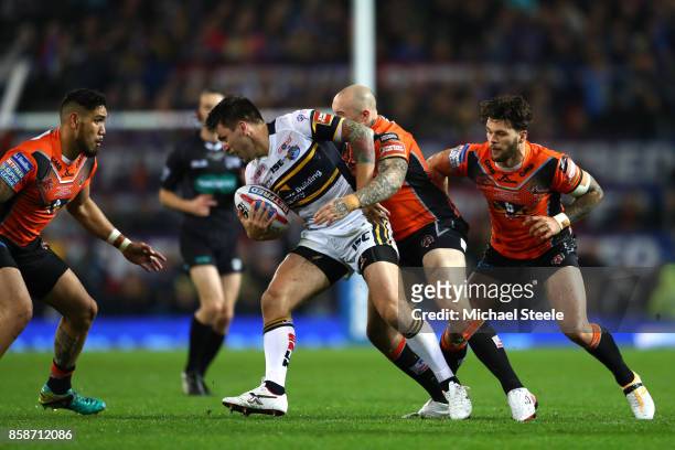 Tom Briscoe of Leeds Rhinos is tackled by Nathan Massey of Castleford Tigers during the Betfred Super League Grand Final match between Castleford...