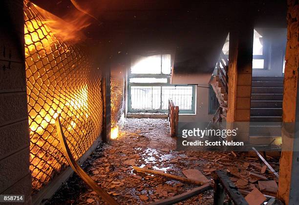 Palestinian shop burns in a downtown Ramallah shopping center following an Israeli tank barrage March 30, 2002 in the center of the West Bank town of...